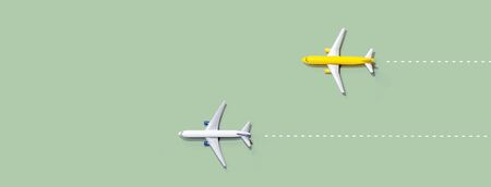 Flights booking and reservation theme with two miniature airplanesの写真素材