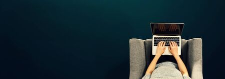 Woman using a laptop computer overhead view