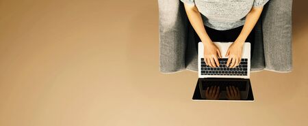 Woman using a laptop computer overhead view