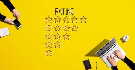 Rating theme with people working together with laptop and phoneの写真素材