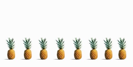 Many pineapples on a solid color background