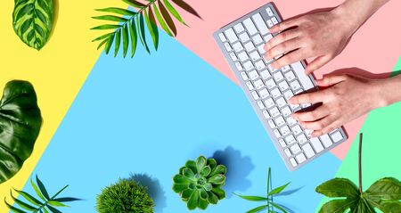 Woman using a computer keyboard - overhead viewの写真素材