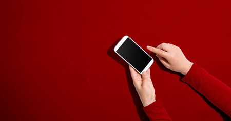 Person using a white smartphone - overhead view