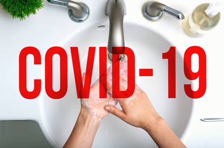 COVID-19 Coronavirus theme with person washing their hands with soap and waterの写真素材