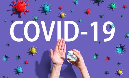 COVID-19 Coronavirus theme with person using hand sanitizerの写真素材
