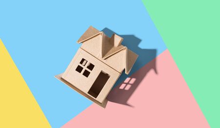 Cardboard house with drop shadow overhead viewの写真素材