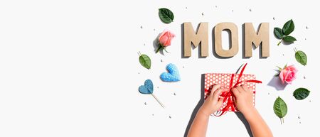 Little boy making a gift box for his mother overhead viewの写真素材