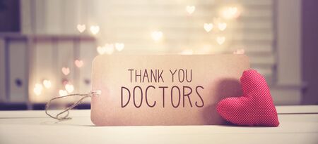 Thank You Doctors message with a red heart with heart shaped lightsの写真素材