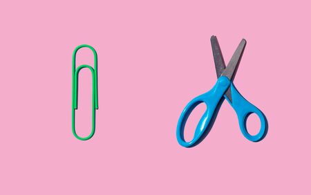 Scissors and a clip with dropped shadow from above - overhead viewの写真素材