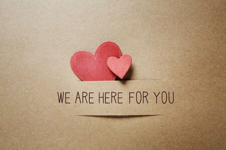 We are Here for You message with handmade small paper heartsの写真素材