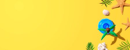 Summer concept with a palm tree float overhead view - flat layの写真素材