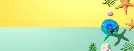 Summer concept with a palm tree float overhead view - flat lay