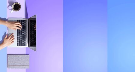 Person using a laptop computer from aboveの写真素材