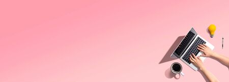 Person using a laptop computer from aboveの写真素材