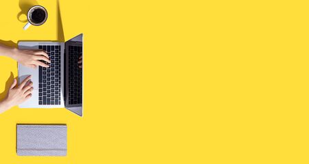 Person using a laptop computer from aboveの写真素材