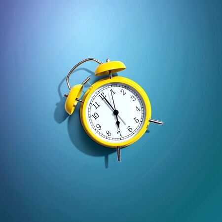 Yellow vintage alarm clock with shadow - flat lay