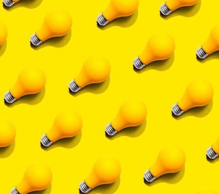 Yellow light bulb pattern with shadow - flat layの写真素材