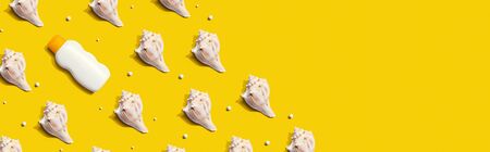 Sunblock bottle with seashells with shadow - flat layの写真素材