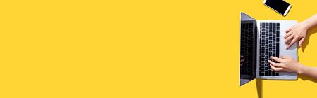 Person using a laptop computer from aboveの写真素材