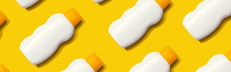 Yellow and white sunblock bottles - flat layの写真素材