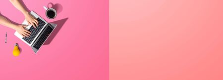 Person using a laptop computer from aboveの写真素材