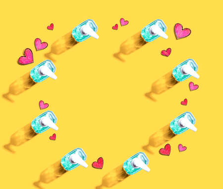 Sanitizer bottles with hand drawing hearts - flat lay