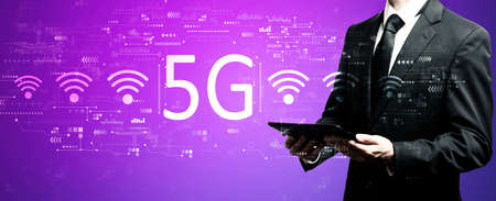 5G network with businessman using his tablet computerの写真素材