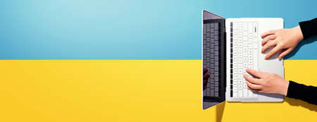 Person using a laptop computer from aboveの写真素材