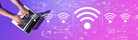Wifi theme with woman using a laptop computerの写真素材