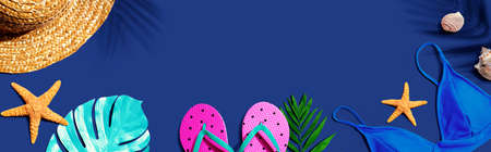 Summer concept with straw hat and swimwear overhead view - flat layの写真素材