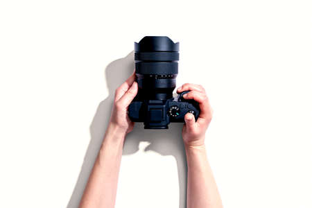 Person holding a SLR camera from aboveの写真素材