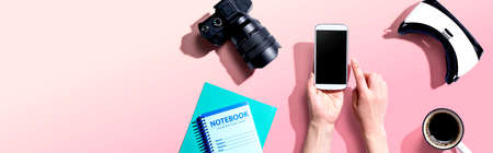 Person using a smartphone with a VR and a SLR cameraの写真素材