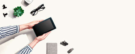 Woman using a tablet computer from aboveの写真素材