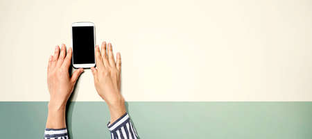 Person using a white smartphone from above