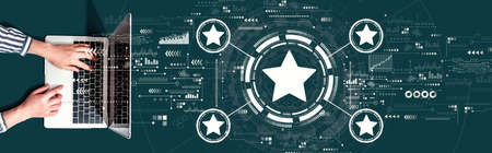 Rating star concept with person using a laptop computer