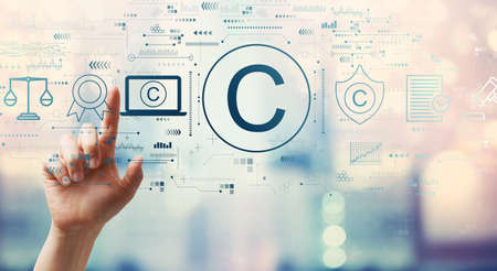 Copyright concept with hand pressing a button on a technology screenの写真素材