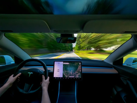 RALEIGH, NC USA, MAY 09, 2020: Person driving a new Tesla Model 3