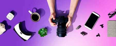Person holding a SLR camera from above