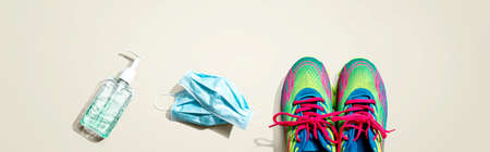Fitness and coronavirus theme with running shoes - flat layの写真素材