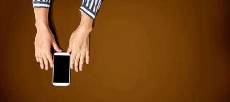 Person using a white smartphone from above