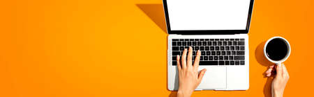 Person using a laptop computer from aboveの写真素材