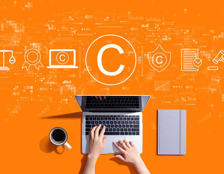 Copyright concept with person using a laptop computerの写真素材