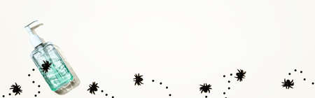Sanitizer bottle with black spiders - Halloween hygiene concept