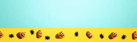 Miniature Halloween pumpkin ghosts with spiders - flat layの写真素材