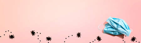 Facial masks with small black spiders - flat layの写真素材