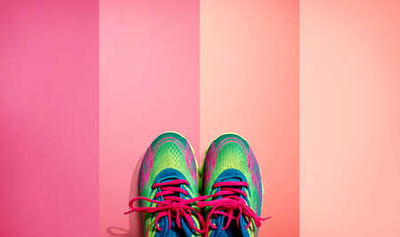 Pair of sport shoes with pink laces - flat layの写真素材