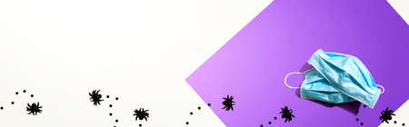 Facial masks with small black spiders - flat layの写真素材