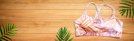 Fitness theme with a sport bra and tropical plants - flat layの写真素材