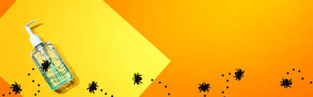 Sanitizer bottle with black spiders - Halloween hygiene conceptの写真素材