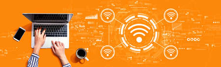 Wifi theme with person using a laptop computerの写真素材